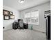 Bedroom with a desk, office chair, large window, and neutral colored carpet at 8175 Sewanee Peak St, Littleton, CO 80125