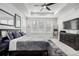 Spacious bedroom with a tray ceiling, large windows, modern decor, and plush rug at 8175 Sewanee Peak St, Littleton, CO 80125