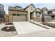 Attractive two-story home with stone accents, a two-car garage, and a concrete driveway at 8175 Sewanee Peak St, Littleton, CO 80125