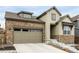Charming home with stone accents, a two-car garage, and inviting curb appeal at 8175 Sewanee Peak St, Littleton, CO 80125