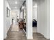 Hallway featuring modern decor, wood-look floors, stylish accents, and access to living space at 8175 Sewanee Peak St, Littleton, CO 80125