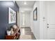 Hallway featuring modern decor, wood-look floors, stylish accents, and a bright entry at 8175 Sewanee Peak St, Littleton, CO 80125