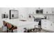 Modern kitchen with white cabinets, stainless steel appliances, and a spacious island at 8175 Sewanee Peak St, Littleton, CO 80125