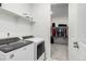Functional laundry area with a modern washer and dryer, with entry to the walk-in closet at 8175 Sewanee Peak St, Littleton, CO 80125