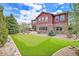House exterior and backyard with putting green at 7999 S Blackstone Pkwy, Aurora, CO 80016
