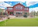 House exterior and backyard with putting green at 7999 S Blackstone Pkwy, Aurora, CO 80016