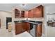 Basement wet bar with dark wood cabinets and mini-fridge at 7999 S Blackstone Pkwy, Aurora, CO 80016