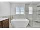 Spa-like bathroom with soaking tub, walk-in shower, and modern vanity at 7999 S Blackstone Pkwy, Aurora, CO 80016