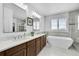 Luxurious bathroom with double vanity and soaking tub at 7999 S Blackstone Pkwy, Aurora, CO 80016