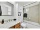 Clean bathroom with single vanity, shower/tub combo, and updated fixtures at 7999 S Blackstone Pkwy, Aurora, CO 80016