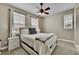 Well-lit bedroom with ceiling fan and window coverings at 7999 S Blackstone Pkwy, Aurora, CO 80016