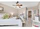 Spacious bedroom with ceiling fan and access to hallway at 7999 S Blackstone Pkwy, Aurora, CO 80016