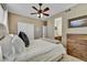 Comfortable bedroom with ceiling fan and dresser at 7999 S Blackstone Pkwy, Aurora, CO 80016