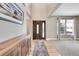 Bright entryway with hardwood floors, a wooden console table, and large windows at 7999 S Blackstone Pkwy, Aurora, CO 80016