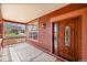 Charming front porch featuring stained-wood columns, a beautiful stained-wood door with glass inserts, and outdoor lighting at 7999 S Blackstone Pkwy, Aurora, CO 80016