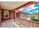 Covered porch with stone and wood details, offering a view of the neighborhood at 7999 S Blackstone Pkwy, Aurora, CO 80016