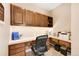 Home office with built-in desk and cabinets at 7999 S Blackstone Pkwy, Aurora, CO 80016