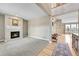 Spacious living room with fireplace, hardwood floors, and large windows at 7999 S Blackstone Pkwy, Aurora, CO 80016
