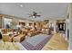 Open living room with hardwood floors, leather furniture, and access to kitchen at 7999 S Blackstone Pkwy, Aurora, CO 80016