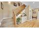 Elegant staircase with wooden railing and decorative console table at 7999 S Blackstone Pkwy, Aurora, CO 80016