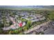 Bird's eye view of a townhouse complex with mature trees and mountain views in the background at 10735 W Dartmouth Ave, Lakewood, CO 80227