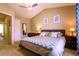 Well-lit bedroom featuring a ceiling fan, neutral-toned walls, and a comfortable bed with stylish bedding at 10735 W Dartmouth Ave, Lakewood, CO 80227