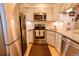 Well-equipped kitchen boasts stainless steel appliances, white cabinets, and granite counters at 10735 W Dartmouth Ave, Lakewood, CO 80227