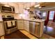 Bright kitchen featuring stainless appliances, white cabinets, and granite countertops at 10735 W Dartmouth Ave, Lakewood, CO 80227