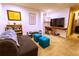 This living room features carpet flooring, a mounted TV, and decor at 10735 W Dartmouth Ave, Lakewood, CO 80227