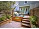 Private outdoor patio featuring stone floor, lush foliage, a seating area and privacy fence at 10735 W Dartmouth Ave, Lakewood, CO 80227
