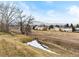 Scenic backyard view of a property, showcasing the natural landscape and surrounding homes at 12089 W Chenango Dr, Morrison, CO 80465