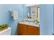 Bright bathroom features a light wood vanity with a white sink and a large mirror at 12089 W Chenango Dr, Morrison, CO 80465