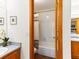 Bathroom view through an open door with a shower/tub, a toilet and a sink at 12089 W Chenango Dr, Morrison, CO 80465