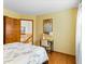 Bright bedroom showcasing a bed, a desk, and a view of the upstairs hallway at 12089 W Chenango Dr, Morrison, CO 80465