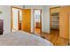 Bedroom showing doors to a bathroom and closet, and hardwood flooring at 12089 W Chenango Dr, Morrison, CO 80465
