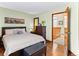 Stylish bedroom with a bed, hardwood floors, and an open doorway to an upstairs hallway at 12089 W Chenango Dr, Morrison, CO 80465