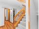 Bright entryway featuring hardwood floors, carpeted stairs, and modern lighting at 12089 W Chenango Dr, Morrison, CO 80465