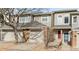 Charming townhouse featuring a brick facade, attached garages, and a well-maintained walkway to the front doors at 12089 W Chenango Dr, Morrison, CO 80465