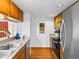 Efficient kitchen with a stainless steel sink, modern appliances, and wooden flooring at 12089 W Chenango Dr, Morrison, CO 80465