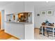 Open kitchen area with a breakfast bar, stainless steel appliances, and modern decor at 12089 W Chenango Dr, Morrison, CO 80465