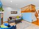 Comfortable living room showcasing neutral carpet, a fireplace, and staircase at 12089 W Chenango Dr, Morrison, CO 80465