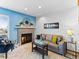 Cozy living room with a brick fireplace, neutral carpet, and stylish decor at 12089 W Chenango Dr, Morrison, CO 80465