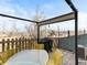 Outdoor patio features a covered pergola, a barbecue grill, and outdoor dining furniture at 12089 W Chenango Dr, Morrison, CO 80465