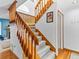 Carpeted staircase with wooden railing, leading to the upper level and rooms at 12089 W Chenango Dr, Morrison, CO 80465