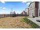 Wide backyard with a partially fenced border, a trampoline, and a concrete patio, ideal for recreation and leisure at 432 N Patsburg St, Aurora, CO 80018