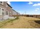 Partially fenced backyard with grass, a concrete patio, and a view of neighboring homes for outdoor enjoyment at 432 N Patsburg St, Aurora, CO 80018