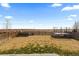 Spacious, fenced backyard with a trampoline, grass, and a view of the open landscape for recreation and outdoor enjoyment at 432 N Patsburg St, Aurora, CO 80018