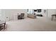 Open basement featuring neutral carpet, a work area, and a comfortable seating area with a TV for relaxing and entertainment at 432 N Patsburg St, Aurora, CO 80018