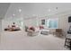 Finished basement with an open concept living area, bedroom, and study nook featuring a large window and neutral tones at 432 N Patsburg St, Aurora, CO 80018
