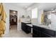 Bathroom with double vanity, granite countertop, modern fixtures, and a view into the walk-in closet at 432 N Patsburg St, Aurora, CO 80018